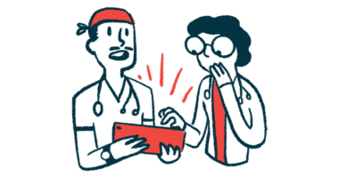 Two doctors confer while interacting with a tablet.