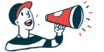 A person in a baseball cap speaks through a megaphone.